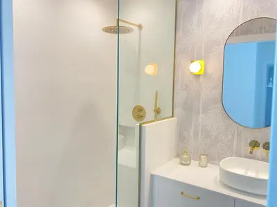 a white bathroom with a sink and a mirror at oh la life! at the top in Santiago de Compostela