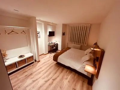 a small bedroom with a bed and a mirror at A Reigada Hotel Restaurante in Grandas de Salime