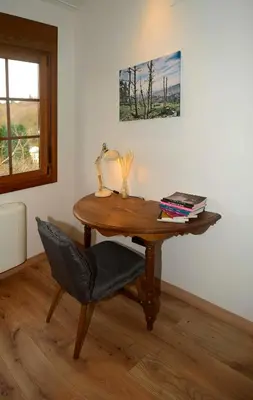 a wooden desk with a chair and a lamp on it at A Reigada Hotel Restaurante in Grandas de Salime