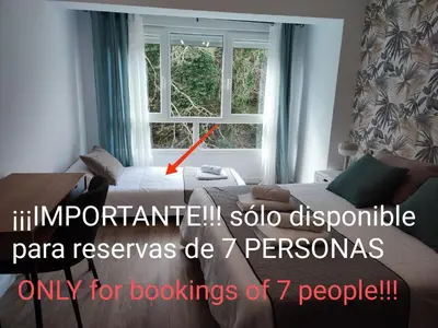 a living room with a bed and a window at O Paseo, 5 estrellas. in Puentedeume