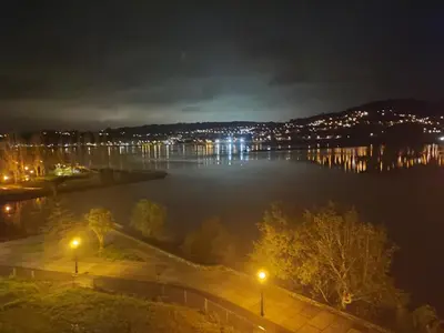 a view of a large body of water at night at O Paseo, 5 estrellas. in Puentedeume