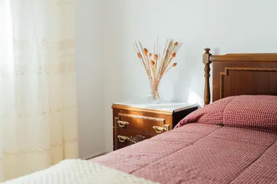 a bedroom with a bed and a vase on a night stand at Casa Cuco in Corejido