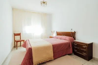 a bedroom with a bed with a dresser and a chair at Casa Cuco in Corejido