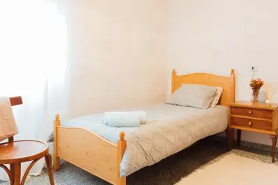 a bedroom with a wooden bed and a wooden nightstand at Casa Cuco in Corejido