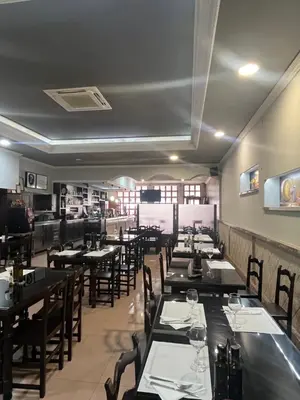 a dining room with tables and chairs in a restaurant at Hostal-Restaurante San Roque in Verín