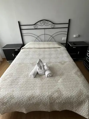 a pair of white shoes sitting on a bed at Hostal-Restaurante San Roque in Verín