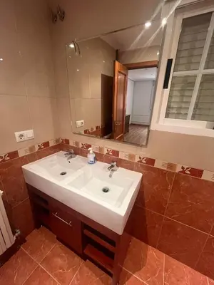 a bathroom with a sink and a mirror at Hostal-Restaurante San Roque in Verín