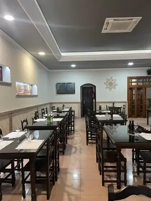 a restaurant with tables and chairs in a room at Hostal-Restaurante San Roque in Verín