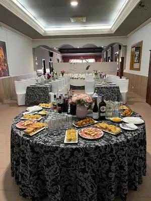 a table with plates of food and drinks on it at Hostal-Restaurante San Roque in Verín