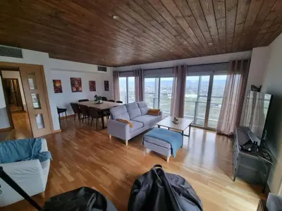 a living room with a couch and a table at El mirador del Rosal in Ponferrada