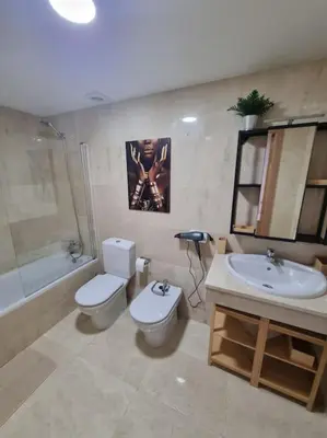 a bathroom with a toilet and a sink and a tub at El mirador del Rosal in Ponferrada