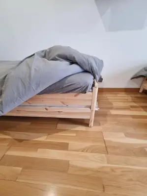 a bed sitting on top of a wooden floor at El mirador del Rosal in Ponferrada