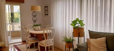 a living room with a table and chairs and a couch at Solerma in Viveiro