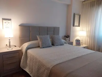 a bedroom with a large bed with two pillows at Solerma in Viveiro