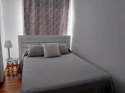 a bed with two pillows in a bedroom with a window at Solerma in Viveiro