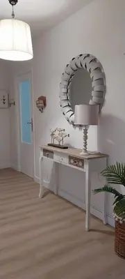a room with a table with a mirror and a lamp at Solerma in Viveiro