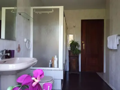 a bathroom with a sink and a toilet and a mirror at Lar A Rola El precio x una noche es para dia y medio Check in 9am Out 21pm in Sabucedo