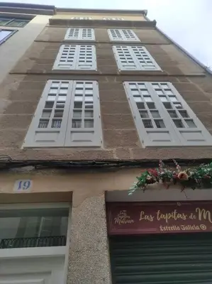 a tall brick building with white windows on it at Lepanto3 - Apartamento amplio y luminoso para disfrutar de Ourense in Ourense