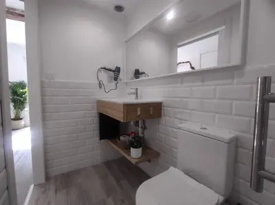 a bathroom with a toilet and a sink and a mirror at Lepanto3 - Apartamento amplio y luminoso para disfrutar de Ourense in Ourense