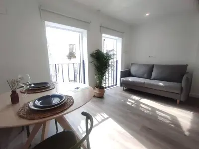 a living room with a table and a couch at Lepanto3 - Apartamento amplio y luminoso para disfrutar de Ourense in Ourense