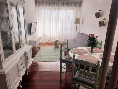 a living room with a table and a couch at Apartamento En Camino - Milladoiro in Milladoiro