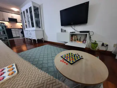 a living room with a table and a flat screen tv at Apartamento En Camino - Milladoiro in Milladoiro