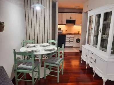 a dining room with a table and chairs and a kitchen at Apartamento En Camino - Milladoiro in Milladoiro