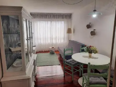 a living room with a table and a couch at Apartamento En Camino - Milladoiro in Milladoiro