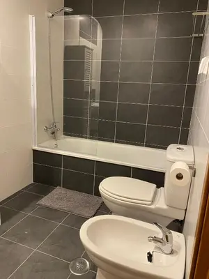 a bathroom with a toilet and a sink and a shower at PRECIOSO ATICO MONDARIZ in Mondariz