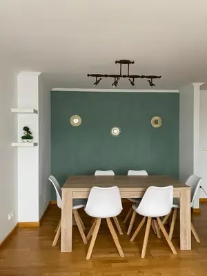 a dining room with a wooden table and white chairs at PRECIOSO ATICO MONDARIZ in Mondariz