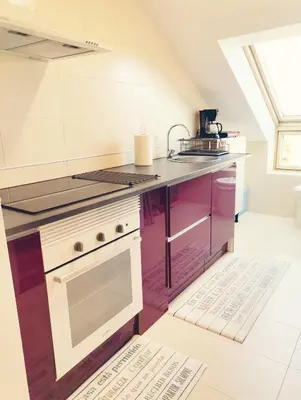a kitchen with a stove and a counter top at PRECIOSO ATICO MONDARIZ in Mondariz