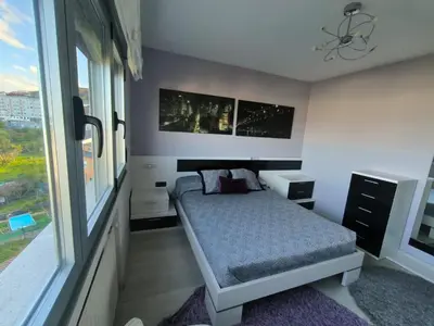 a bedroom with a bed and a large window at Castrelo 4A in Burela de Cabo