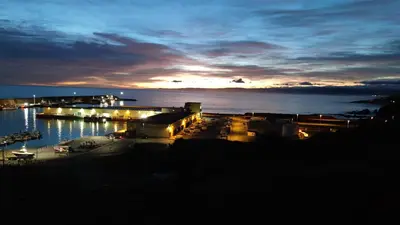 a view of a marina at night at Castrelo 4A in Burela de Cabo
