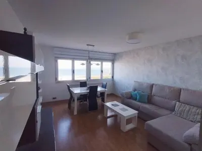 a living room with a couch and a table at Castrelo 4A in Burela de Cabo
