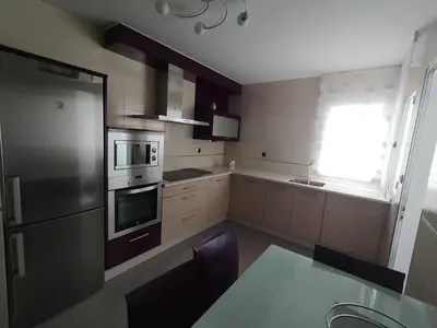 a kitchen with stainless steel appliances and a window at Castrelo 4A in Burela de Cabo
