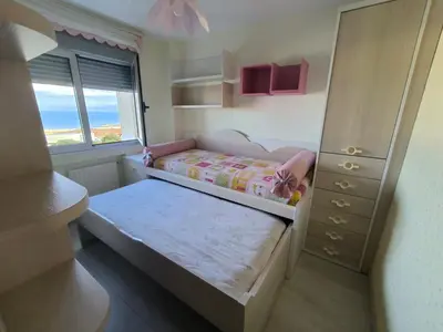 a small bedroom with a bed and a dresser at Castrelo 4A in Burela de Cabo