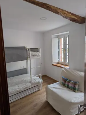 a living room with two bunk beds and a couch at Casa Buenos Aires in Ribadeo