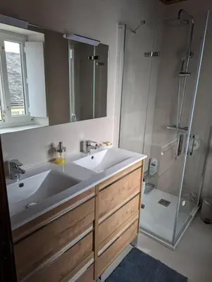 a bathroom with a sink and a shower at Casa Buenos Aires in Ribadeo