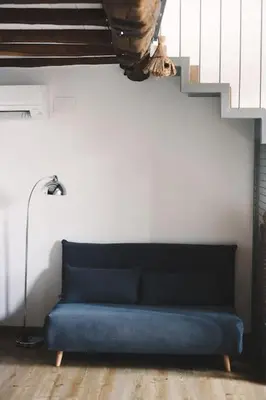 a blue couch in a room with a staircase at Casa Amencer in Francos