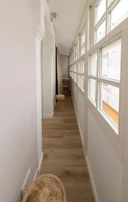 a hallway with a table and a window at NOARU Apartamentos Deluxe in Ares