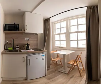 a kitchen with a counter and a table and a window at NOARU Apartamentos Deluxe in Ares
