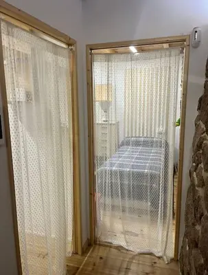 a room with a sliding glass door with a bed outside at O Capricho in Requeixo