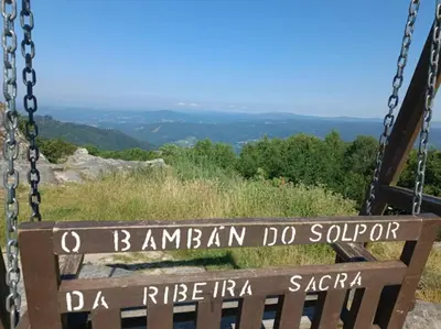 a swinging bench with a sign that reads bramanndan do soriori at O Capricho in Requeixo