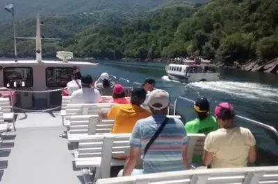 a group of people on a boat on a river at O Capricho in Requeixo