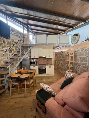 a living room with a couch and a table at O Capricho in Requeixo