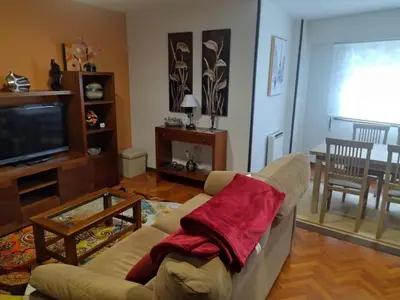 a living room with a couch and a television at Pontedeume cerca del mar y la naturaleza in Puentedeume