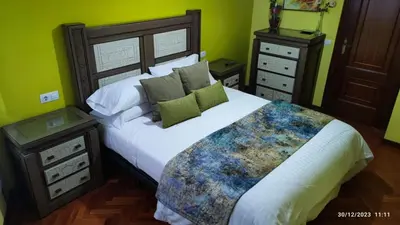 a bedroom with a large bed and two night stands at Pontedeume cerca del mar y la naturaleza in Puentedeume