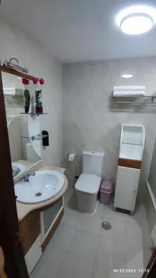 a white bathroom with a toilet and a sink at Pontedeume cerca del mar y la naturaleza in Puentedeume