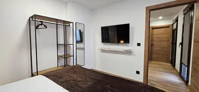 a bedroom with a bed and a tv on a wall at Tierra de Lemos- Apartamentos Turísticos in Monforte de Lemos