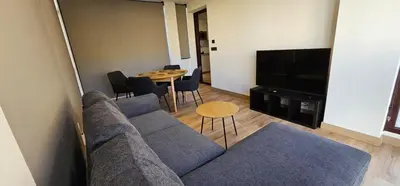 a living room with a couch and a table at Tierra de Lemos- Apartamentos Turísticos in Monforte de Lemos